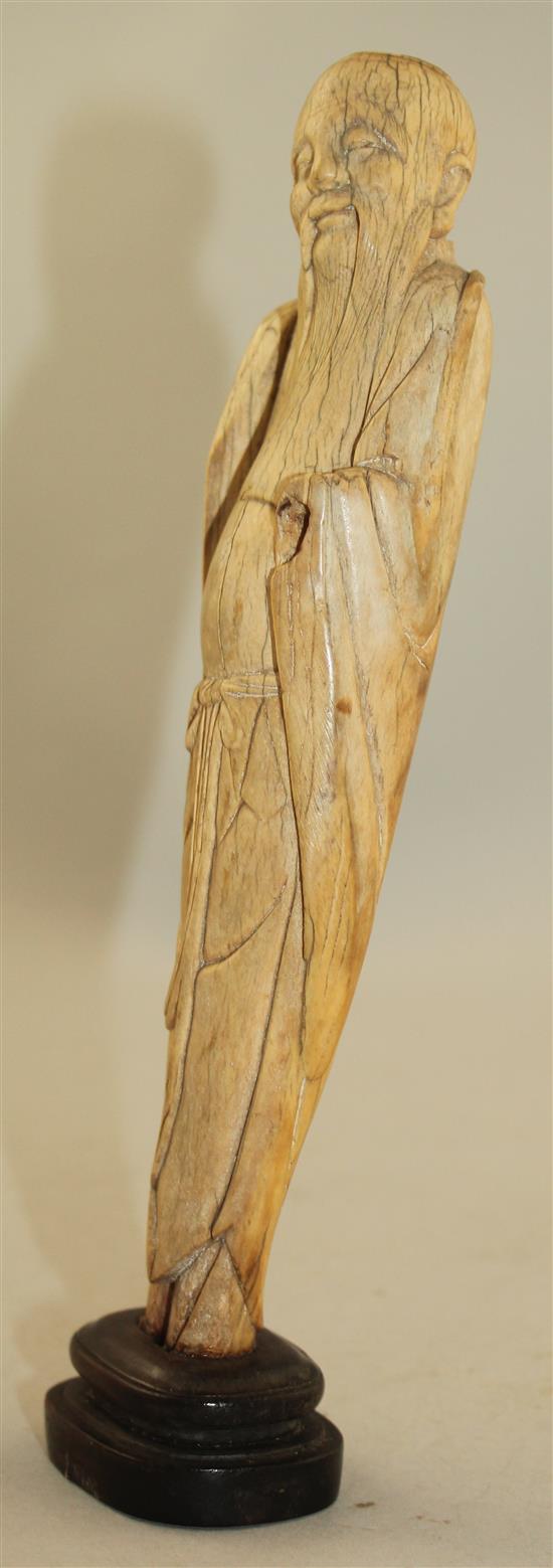 A Chinese ivory figure of an immortal, late Ming dynasty, height 21cm, slight losses and age cracks